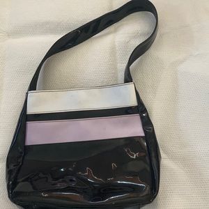 Patent leather , black purse white and light violet stripe on top of purse